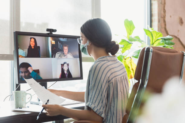 istock Young female teacher teaches elementary students online 1289433154