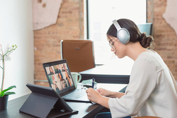 istock Business woman takes notes during virtual meeting with diverse colleagues 1289433244