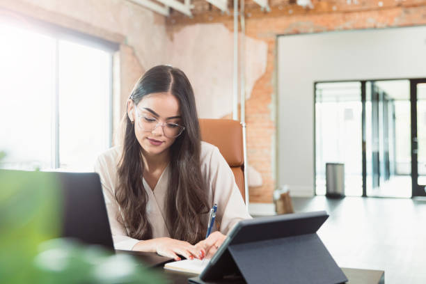 istock Young woman works in empty office during coronavirus shutdown 1289433258