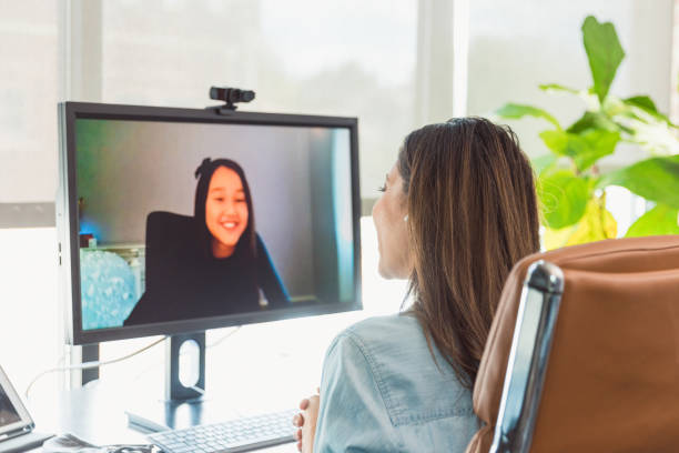 istock Unrecognizable female tutor works online with elementary age girl 1289433293