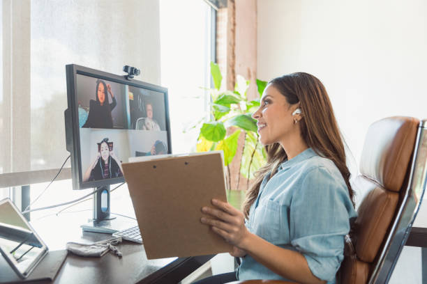 istock Mid adult teacher works with students virtually during COVID-19 1289433301
