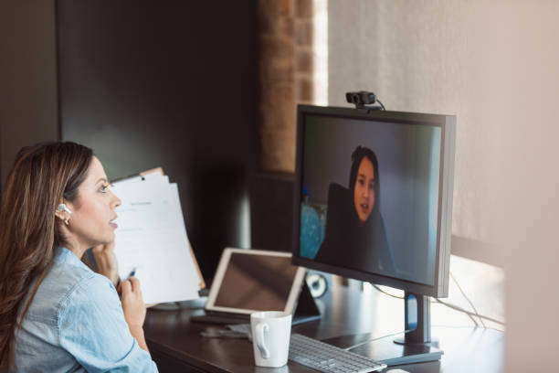 istock Elementary schoolgirl participates in online tutoring session 1289433429