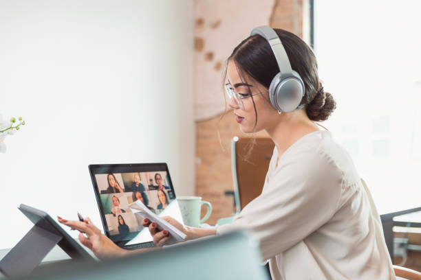 istock Businesswoman talks with colleagues during virtual meeting 1289433484