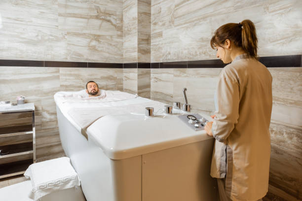 istock Man with a doctor at balneology room with carbon dioxide bath 1289434353