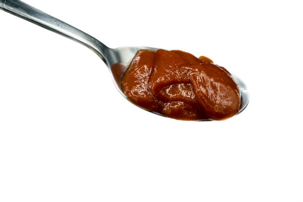 istock Ketchup on spoon isolated on a white background 1289435333