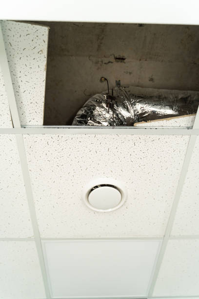 istock One plasterboard moved for ventillation system instulling under celing. Closeup. 1289435353