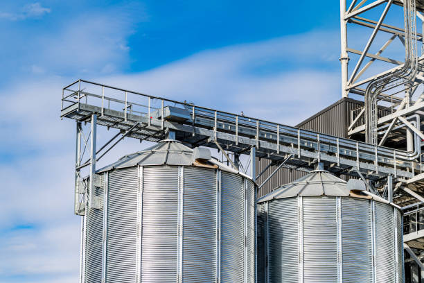 istock Industrial agriculture elevators with harvested grain. Grain cooperative. Closeup. 1289436677