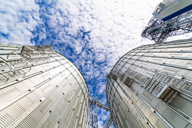 View from below on steel grain elevators. Modern up to date factory. Selective focus.