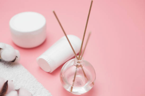 istock spa concept, cotton white jars on a pink background, copy space, top view 1289436963