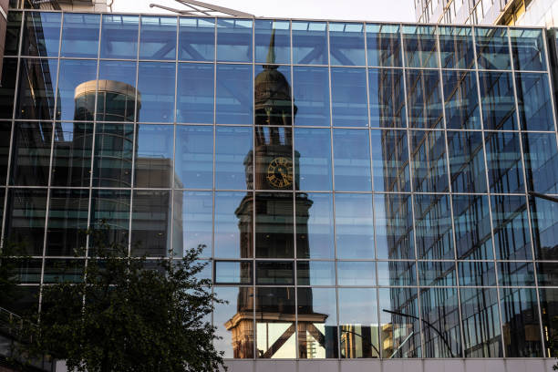 Modern office buildings with the reflection of the bell tower of the St. Michael Church or St Michaelis in Neustadt, Hamburg, Germany