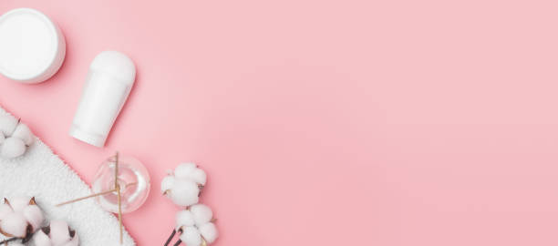 istock spa concept, cotton white jars on a pink background, copy space, top view 1289439563