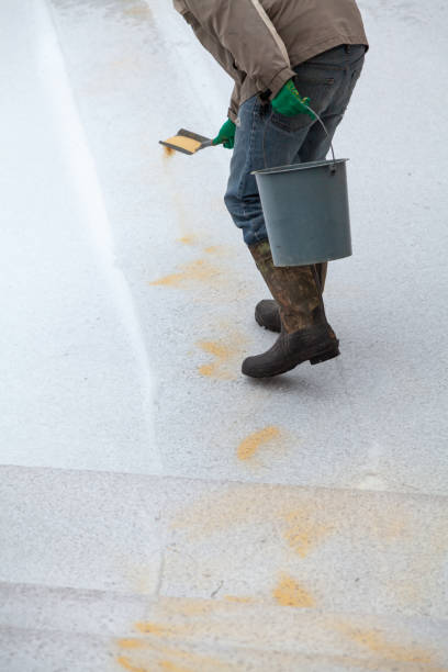 istock Worker sprinkles dry sand on slippery path in yard 1289439689