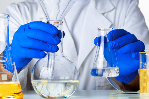 istock Scientist hands holding some liquid in a glassware in laboratory for analysis 1289442799