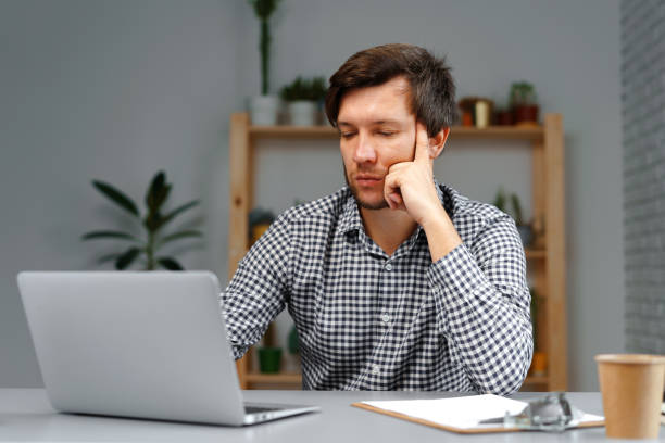 istock Young man working on laptop at his working table 1289442871