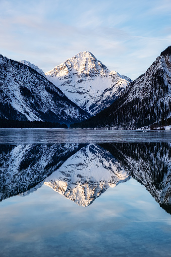 Landscape in Austria. Mountains and reflections in the lake. Winter season.