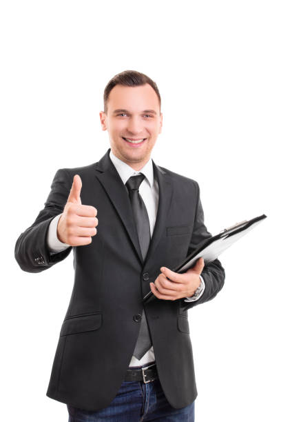 istock Smiling businessman with a clipboard giving thumb up 1289445249