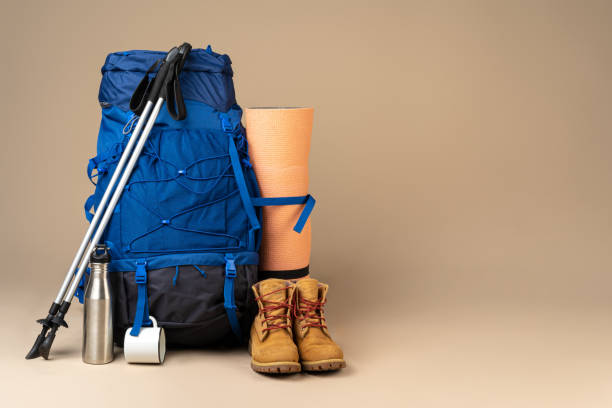 istock Blue backpack and hiking boots. Mountain gear close up 1289445319