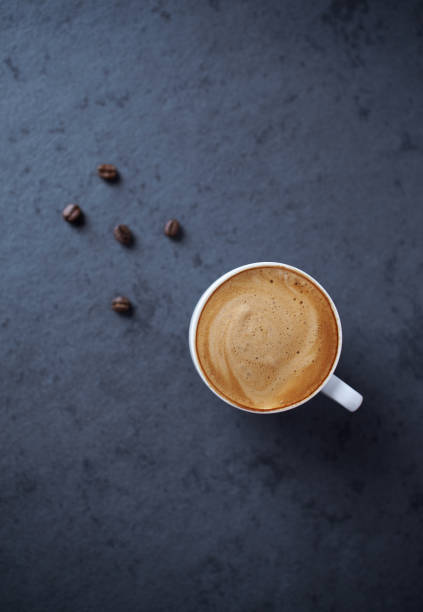 istock Cup of coffee on dark stone background. Top view. Copy space 1289446437