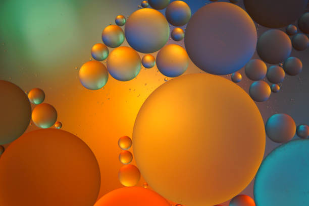 istock Oil drops on a water surface abstract background 1289446674