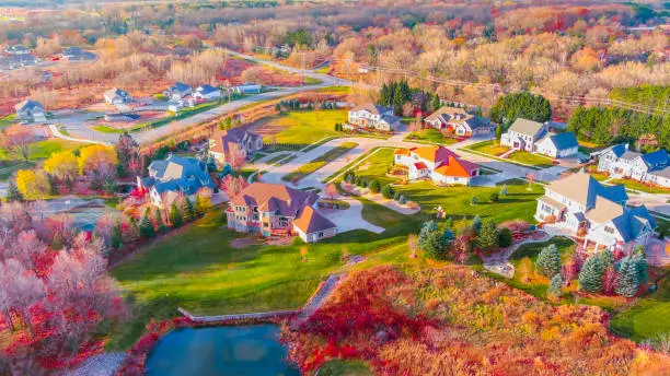 Breathtaking Autumn colors in neighborhood foliage, aerial flyover.