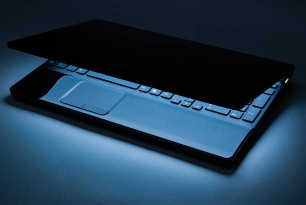 istock The covered laptop with the light in the dark 1289449775