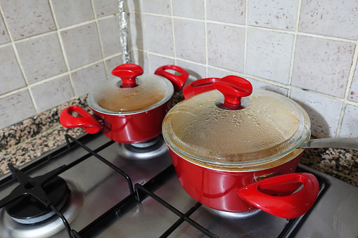 Food is being cooked in red pots