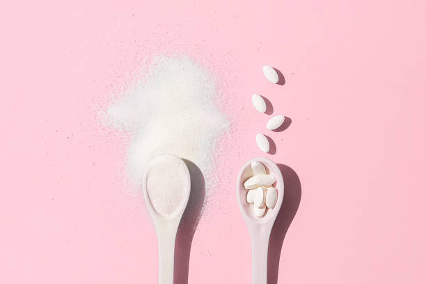 istock Collagen spoons on a pink background. Top view. 1289450726