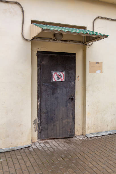 istock Stop COVID-19. Sign on the iron door 1289450865