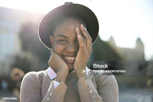 Portrait Of Shy Black Woman Guarding The Joy On Her Face Stock Photo - Download Image Now