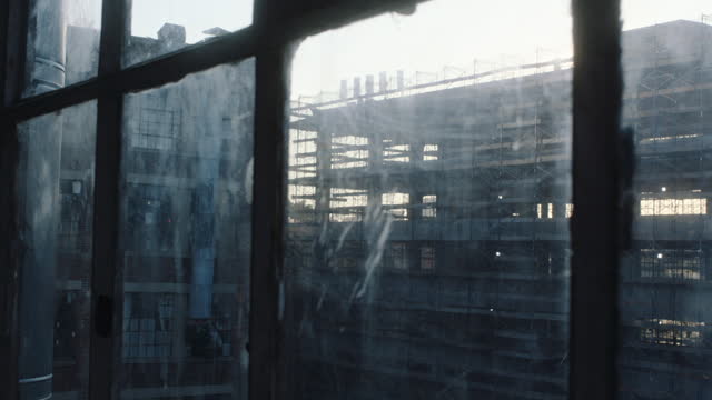 Tracking shot along industrial windows