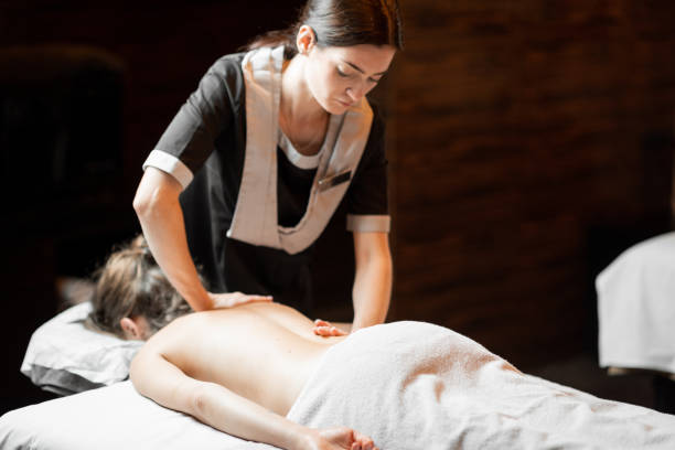 istock Masseur doing back massage to a female client 1289455216