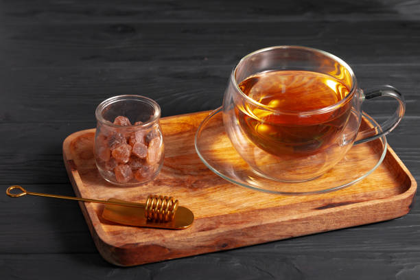 istock Glass cup of tea on wooden board 1289464816