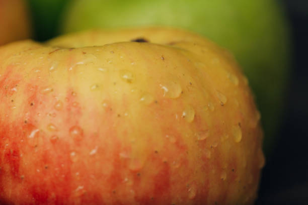 istock Apple Close Up With Water Droplets on the Peel 1289466500
