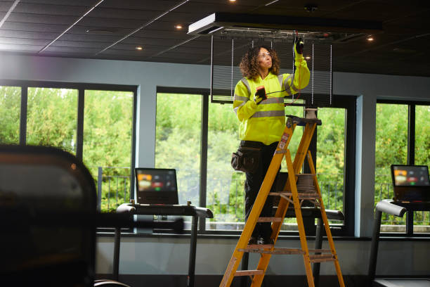 istock female electrician installing aircon 1289466511
