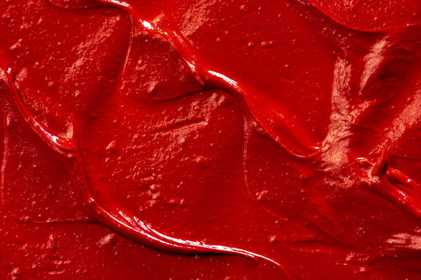 istock Red lipstick background texture smudged. Close up. 1289467058