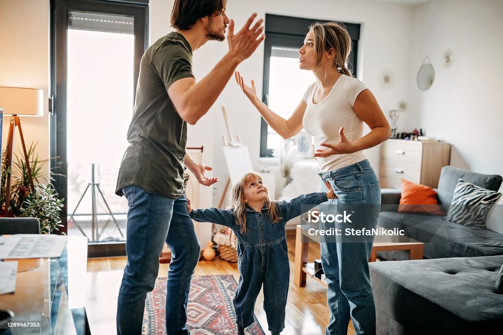 Don't get anger on her Parents have relationship issues, arguing and fighting, wreak one's anger on kid Child Stock Photo