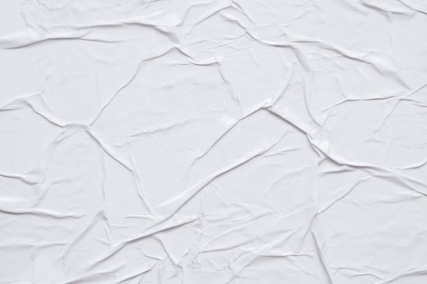 istock Blank white crumpled and creased paper poster texture background 1289467913