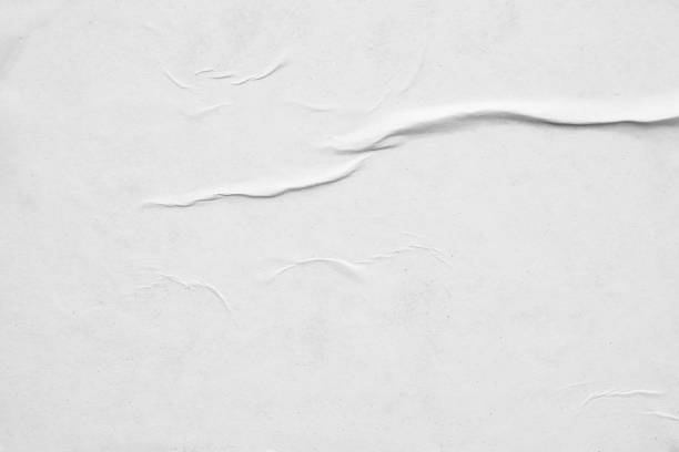istock Blank white crumpled and creased paper poster texture background 1289467918