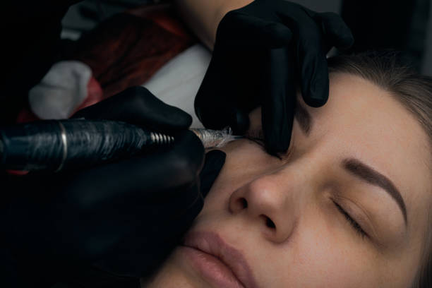 istock Permanent eyebrow makeup procedure. Eyebrow tattooing, process. The use of tools by a master for permanent eyebrow makeup. 1289468007
