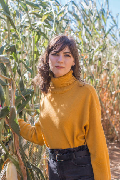 istock Girl stands in a corn field with a serious face 1289468237