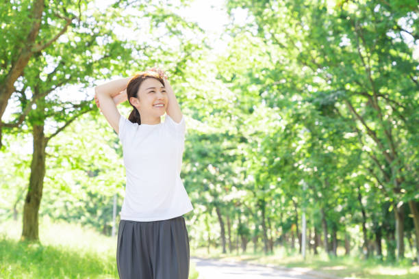 istock asian woman exercising in the park 1289468302