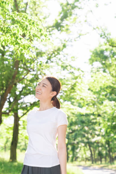 istock asian woman exercising in the park 1289468363