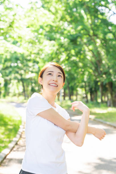 istock asian woman exercising in the park 1289468367