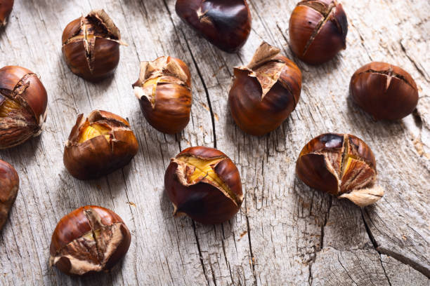 istock Tasty fried chestnut snack background 1289474444