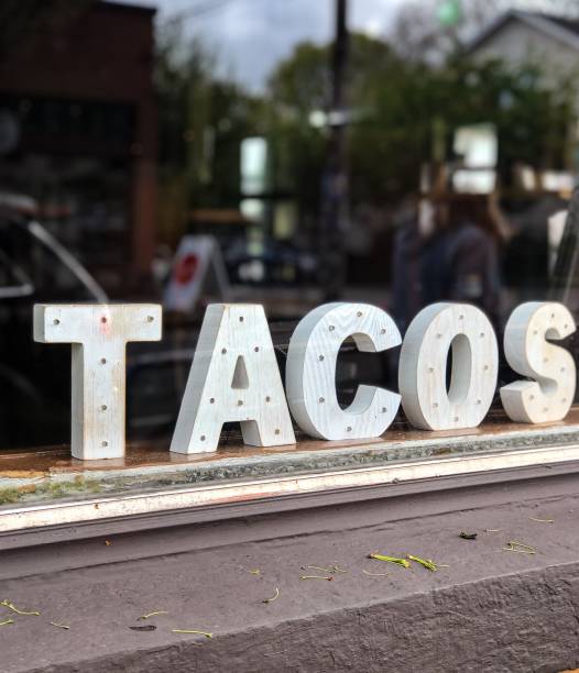 Tacos sign displayed in a restaurant window