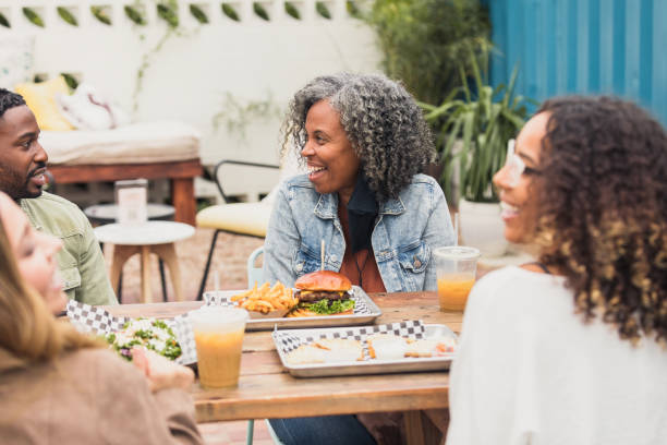 istock Diverse colleagues meet at patio restaurant 1289475376