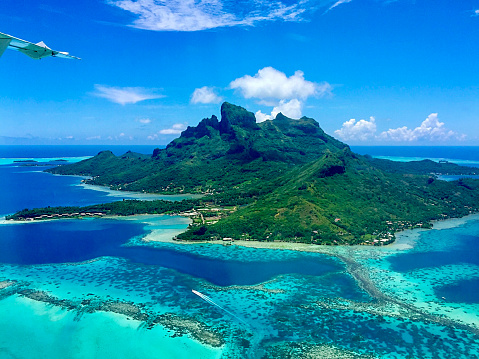 When flying away from Bora Bora island, the Aerial View of the Paradise Bora Bora Island is truly amazing. Here is  Bora Bora Island, the atoll, the lagoon, the resorts and Mt. Otemanu seen from the air.