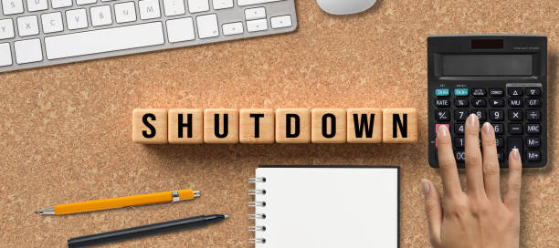 istock wooden cubes with the message SHUTDOWN 1289481354