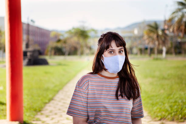 istock Young woman student with protective face mask at college 1289482253