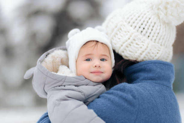 istock Cute Baby Enjoying First Snow in Winter Time 1289488862